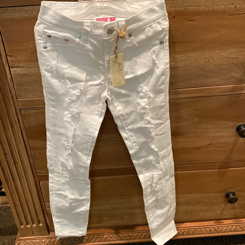 New white jeans vintage style with rips.